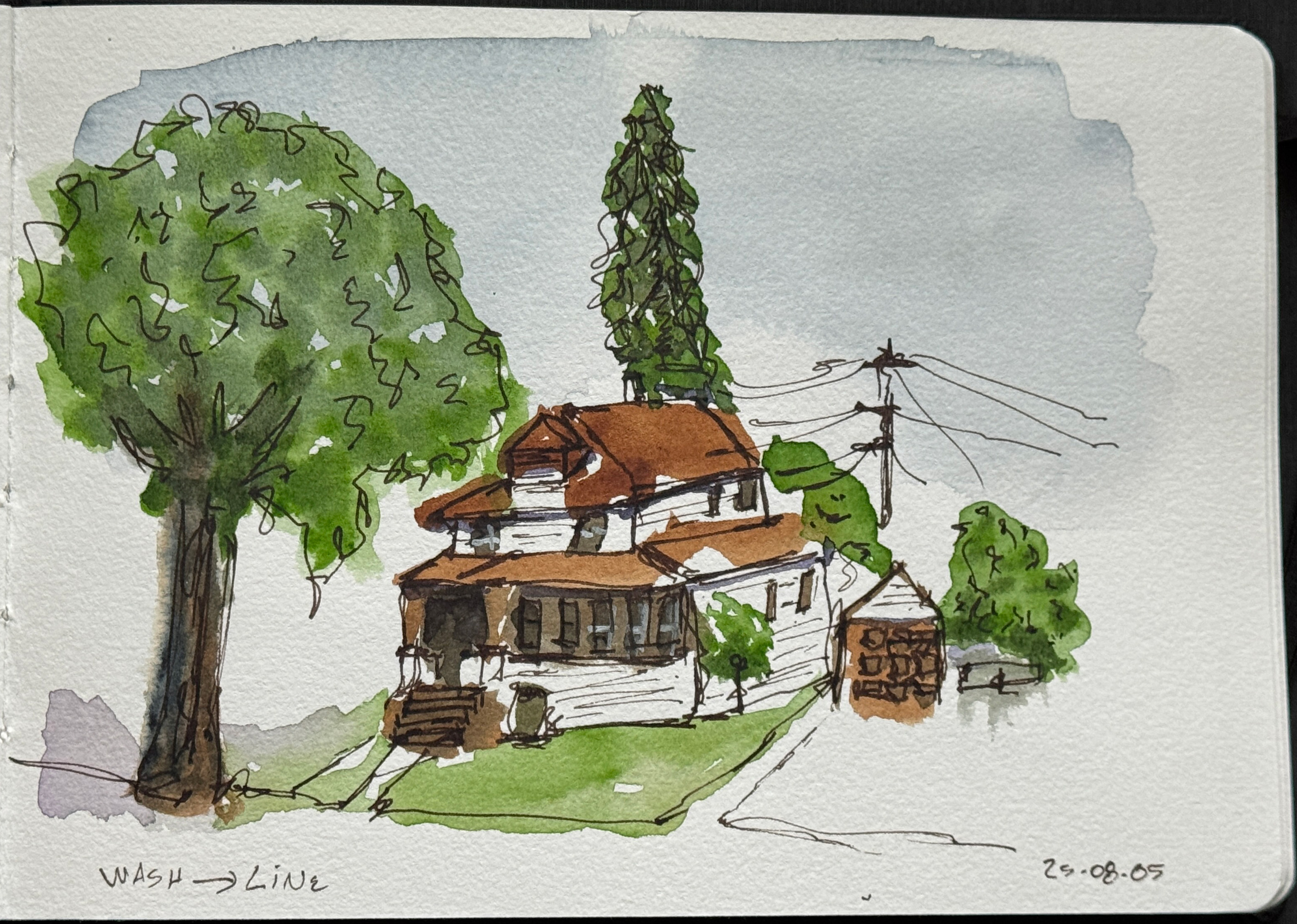 Line and wash sketch. A second version of the other sketch. An older house with a second floor, and a wrap around porch. There is a large tree to the left of the image, near the sidewalk. A small garage to the right of the house, towards the back. A tall evergreen tree directly behind the house.